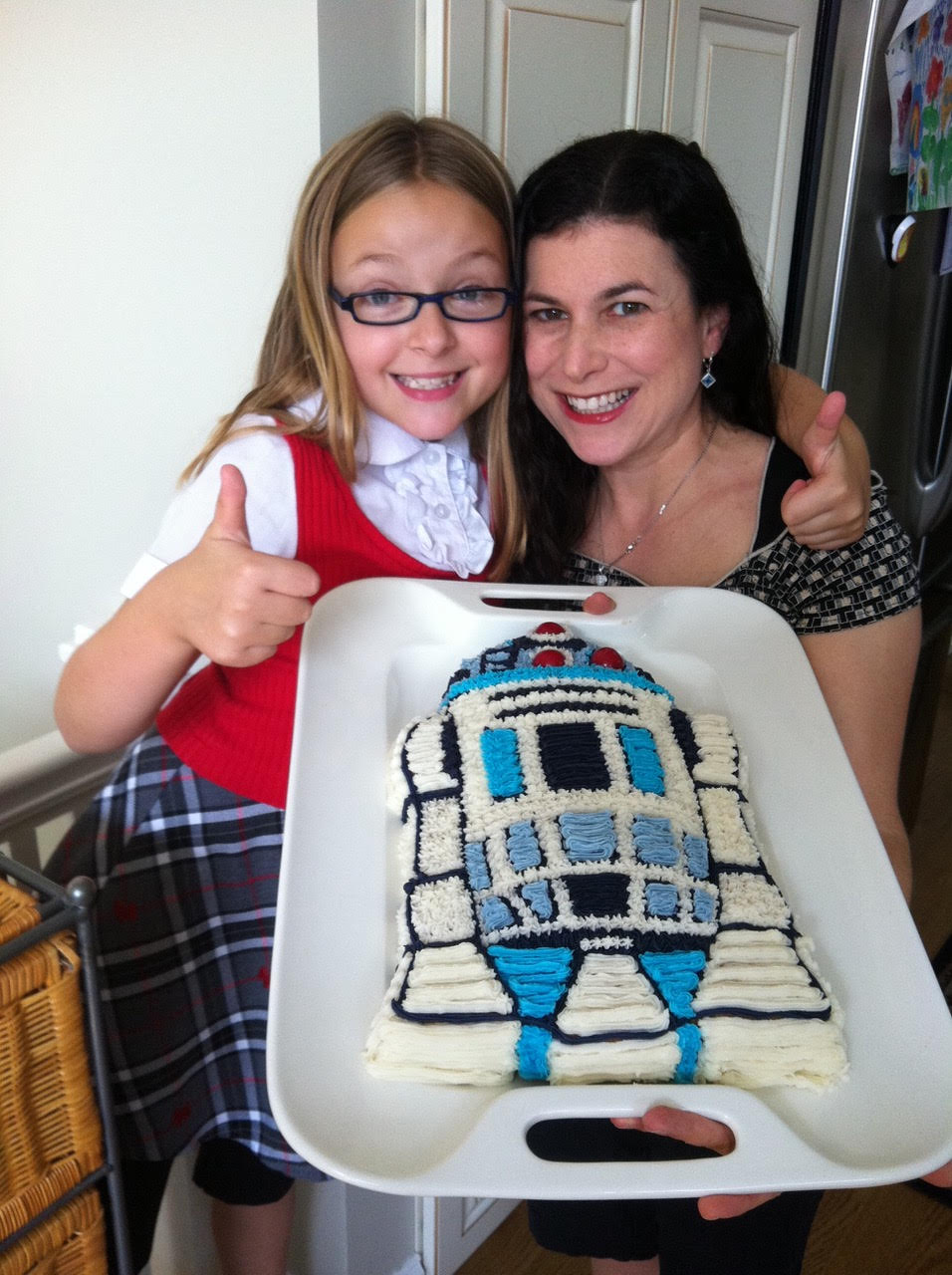 Carrie Goldman and her daughter with a custom R2-D2 cake